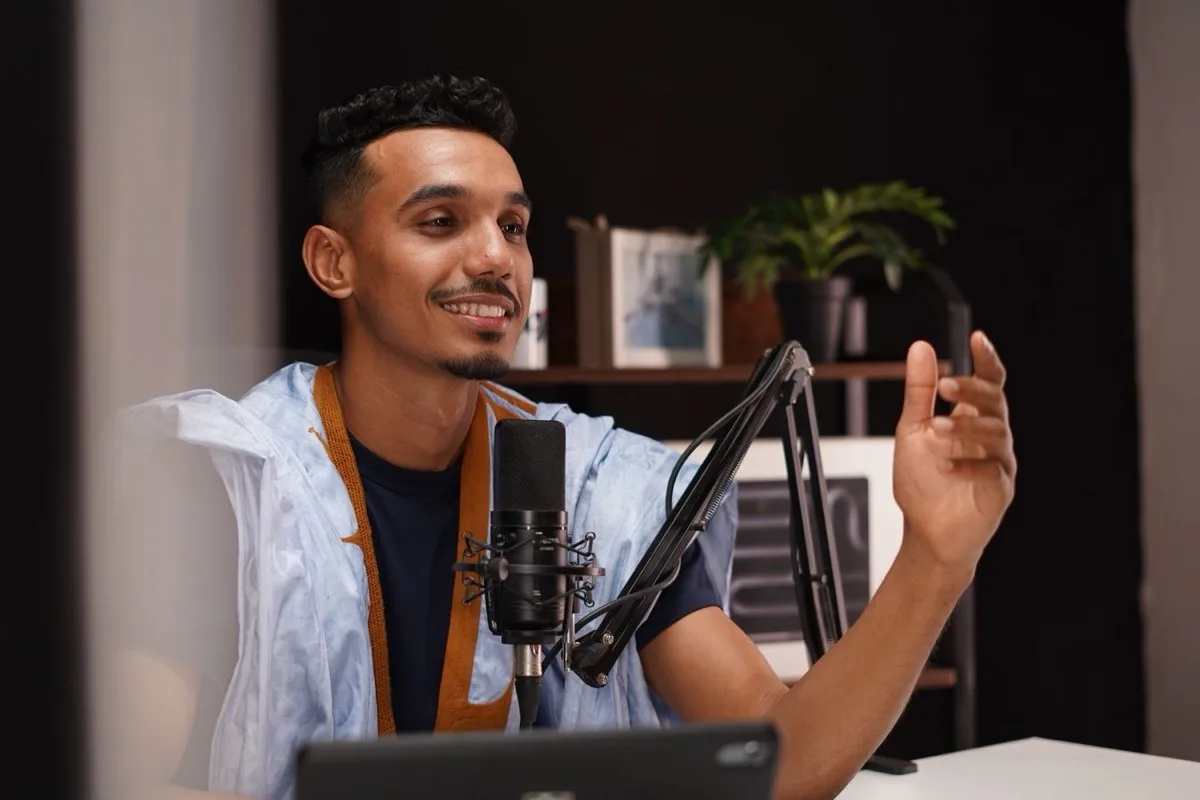 A person speaking into a microphone in a quiet room